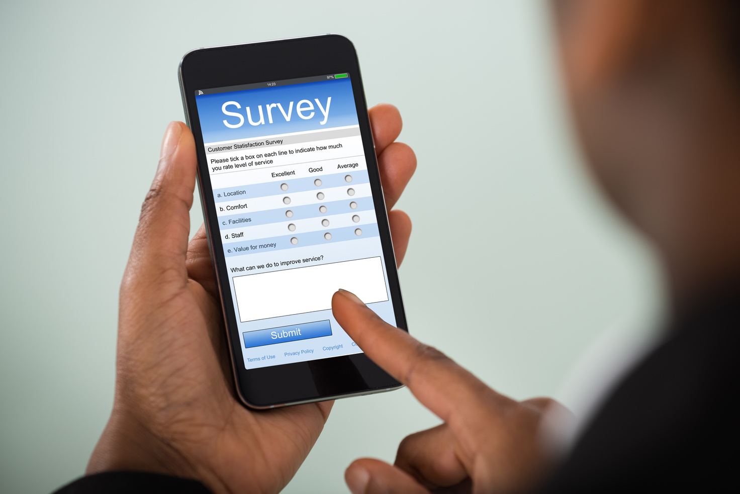 Person Filling Up an Online Survey with a Mobile Phone 